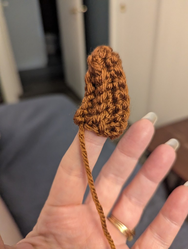 crochet pumpkin stem on finger